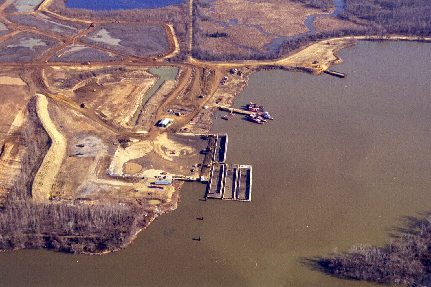 Aerial view of mechanical offloading of dredged material at Weanack Land
